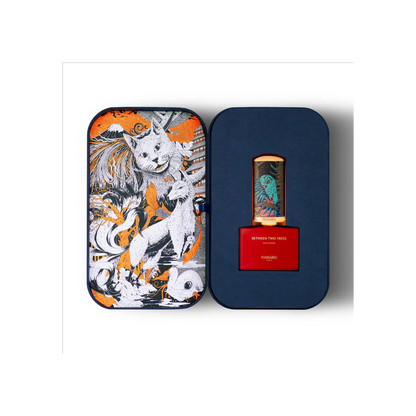 Perfume bottle with decorative packaging featuring a wolf design on an orange background.