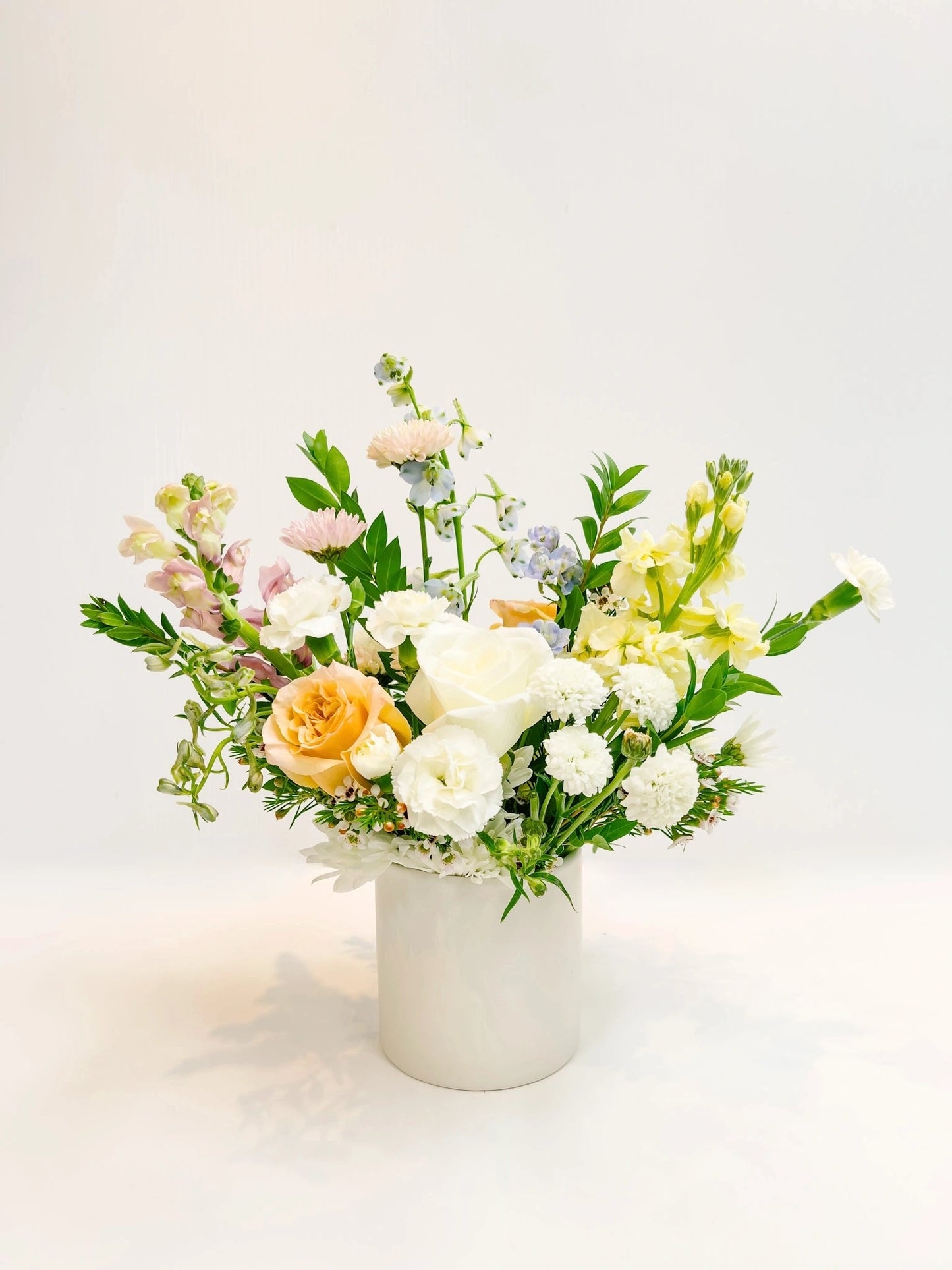 Floral arrangement in a white vase on a light background
