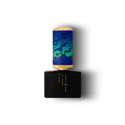 Perfume bottle with blue and green camouflage design on a white background
