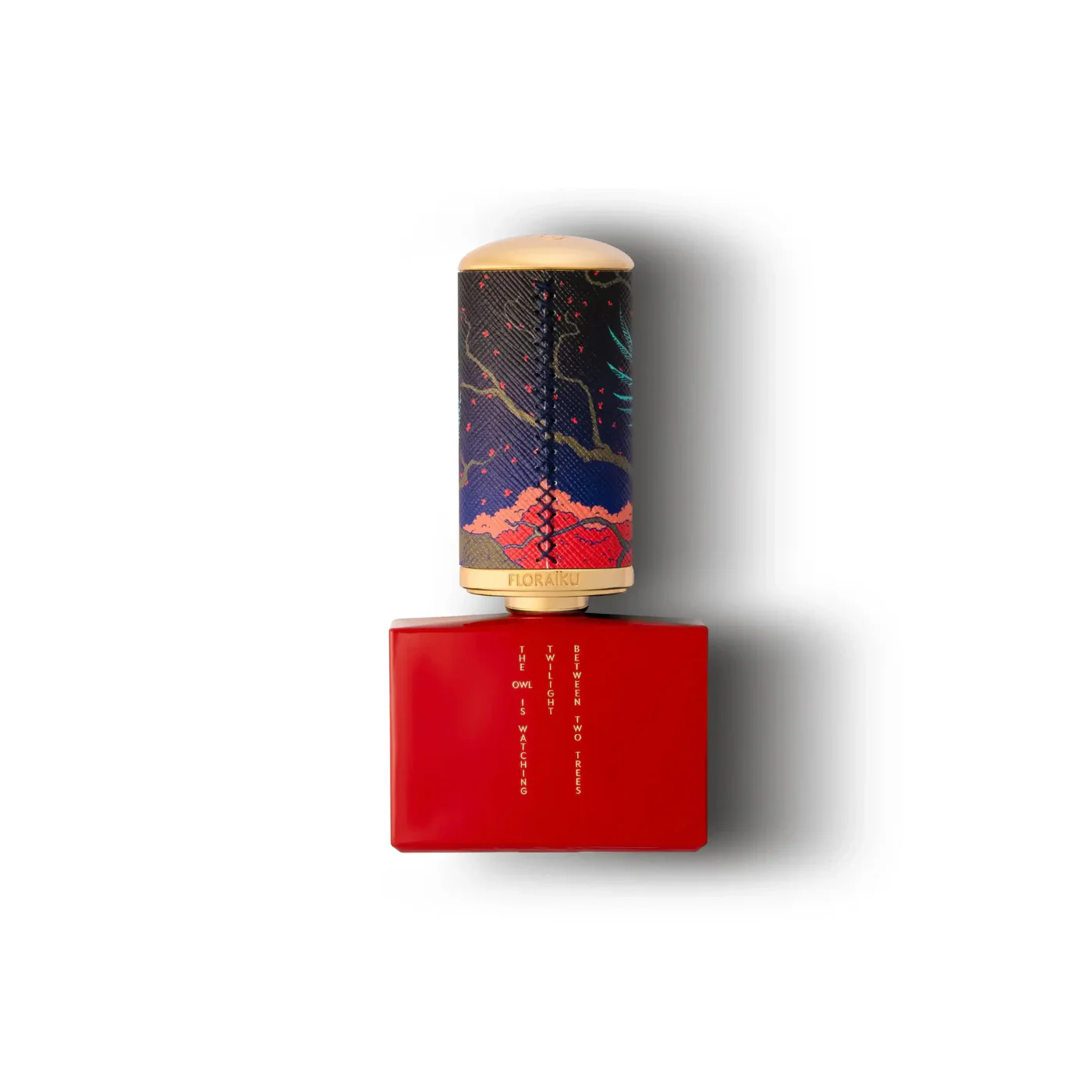 Red perfume bottle with a patterned cap on a white background