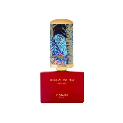 Floraiku perfume bottle with red base and colorful owl design on cap